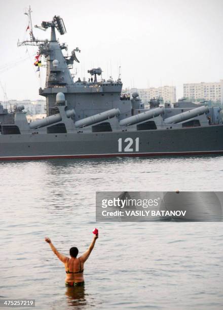 Bather on Sevastopol city beach welcomes Russian missile cruiser Moskva as it entering Sevastopol bay on August 23, 2008. The missile cruiser Moskva...