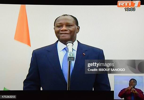 This picture taken on a television screen in Abidjan on February 27, 2014 shows Ivorian president Alassane Ouattara making an announcement during a...