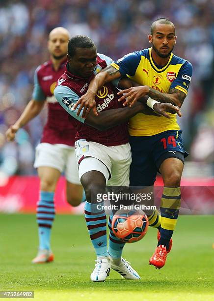 Jores Okore of Aston Villa and Theo Walcott of Arsenal battle for the ball during the FA Cup Final between Aston Villa and Arsenal at Wembley Stadium...