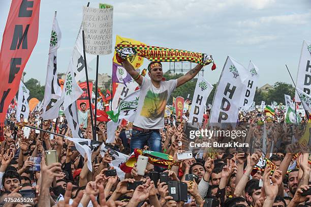 Cheering supporters of Turkey's pro-Kurdish People's Democtratic Party leader Selahattin Demirtas as he addresses a rally ahead of the June 7 general...
