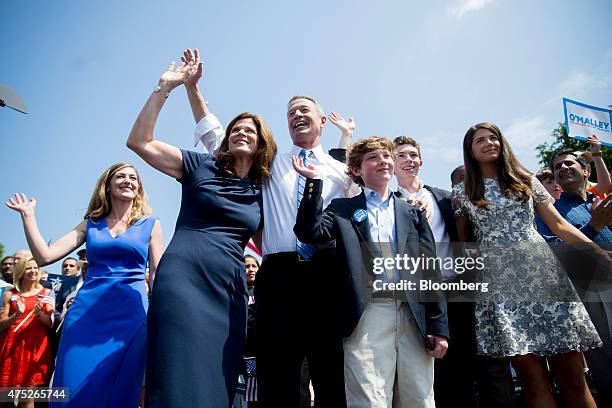 Martin O'Malley, former governor of Maryland, center, waves to the crowd with his wife Katie O'Malley, second from left, and his family after...