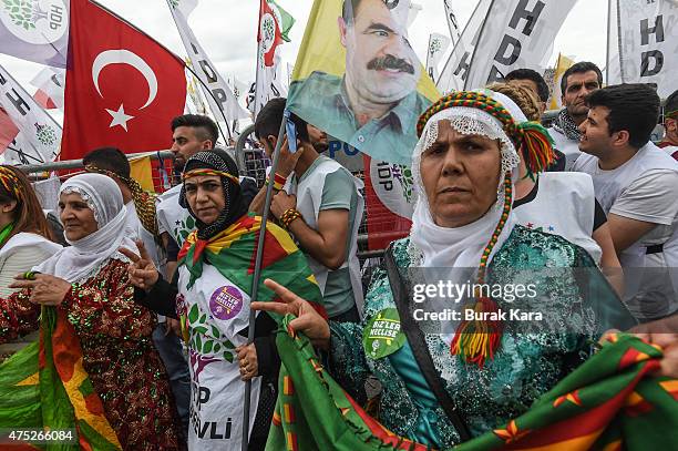 Supporter of Turkey's pro-Kurdish People's Democtratic Party cheer as wave Turkish flags and pictures of jailed Kurdish rebel leader Abdullah Ocalan...