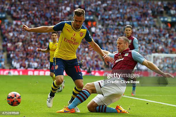 Ron Vlaar of Aston Villa tackles Aaron Ramsey of Arsenal during the FA Cup Final between Aston Villa and Arsenal at Wembley Stadium on May 30, 2015...