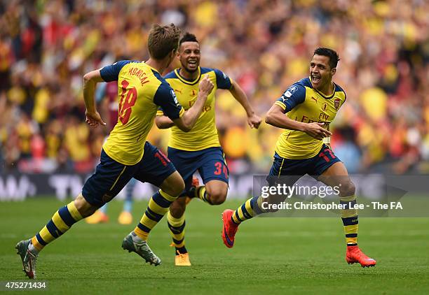 Alexis Sanchez of Arsenal celebrates with his team-mates Nacho Monreal and Francis Coquelin after scoring their second goal during the FA Cup Final...