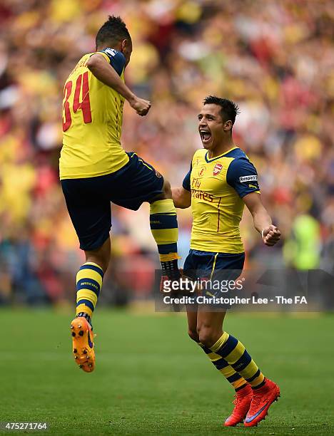 Alexis Sanchez of Arsenal celebrates with his team-mate Francis Coquelin after scoring their second goal during the FA Cup Final between Aston Villa...