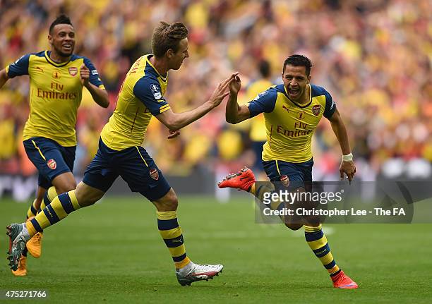 Alexis Sanchez of Arsenal celebrates with his team-mates Nacho Monreal and Francis Coquelin after scoring their second goal during the FA Cup Final...