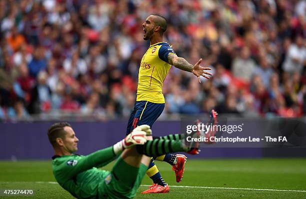 Theo Walcott of Arsenal celebrates next to Shay Given of Aston Villa after his team-mate Alexis Sanchez of Arsenal scored their second goal during...