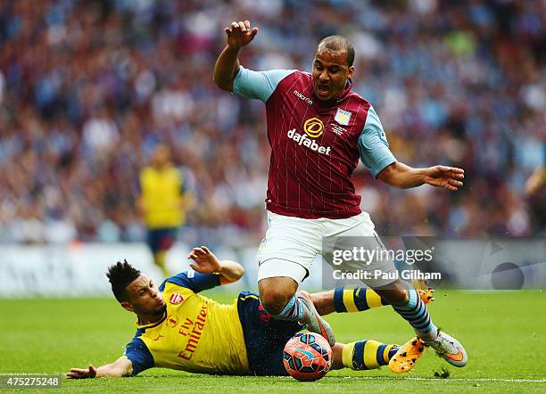 Gabriel Agbonlahor of Aston Villa is challenged by Francis Coquelin of Arsenal during the FA Cup Final between Aston Villa and Arsenal at Wembley...