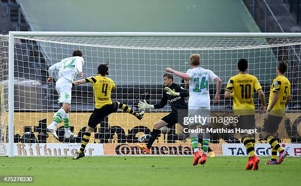 Bas Dost of VfL Wolfsburg scores his team's third goal during the DFB Cup Final match between Borussia Dortmund and VfL Wolfsburg at Olympiastadion...