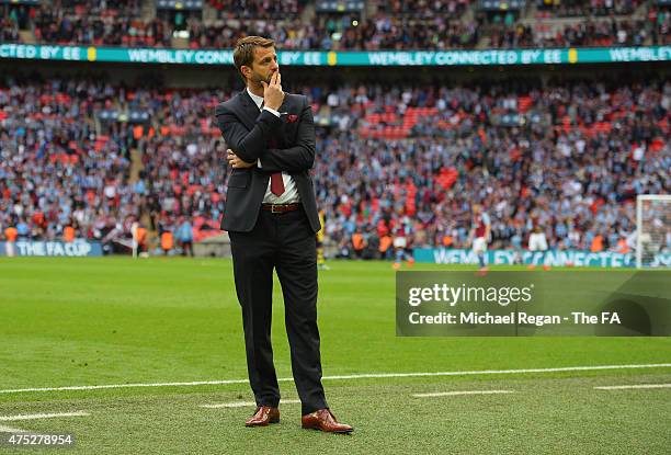 Tim Sherwood manager of Aston Villa shows his dejection on the touchline after his team conceded a fourth goal, which was scored by Olivier Giroud of...