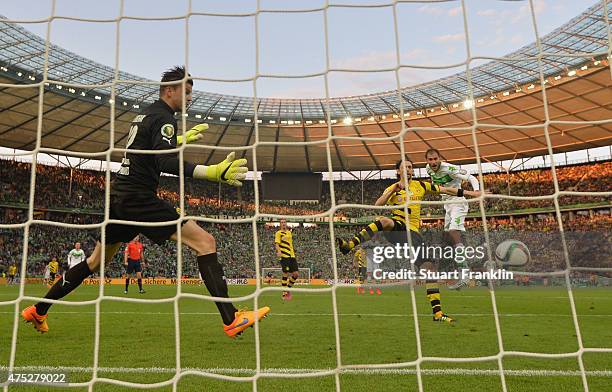 Bas Dost of VfL Wolfsburg heads his teams third goal during the DFB Cup Final match between Borussia Dortmund and VfL Wolfsburg at Olympiastadion on...