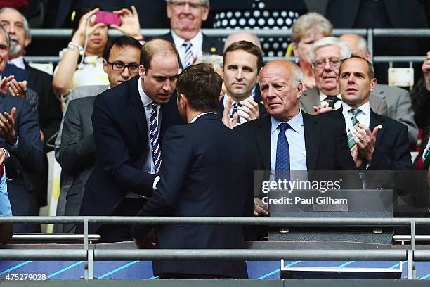 Prince William, Duke of Cambridge presents Tim Sherwood manager of Aston Villa with a runners-up medal as FA Chairman Greg Dyke looks on after the FA...