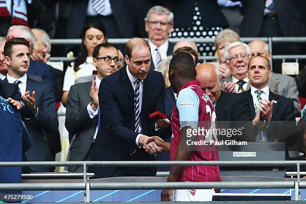 Prince William, Duke of Cambridge presents Christian Benteke of Aston Villa after the FA Cup Final between Aston Villa and Arsenal at Wembley Stadium...
