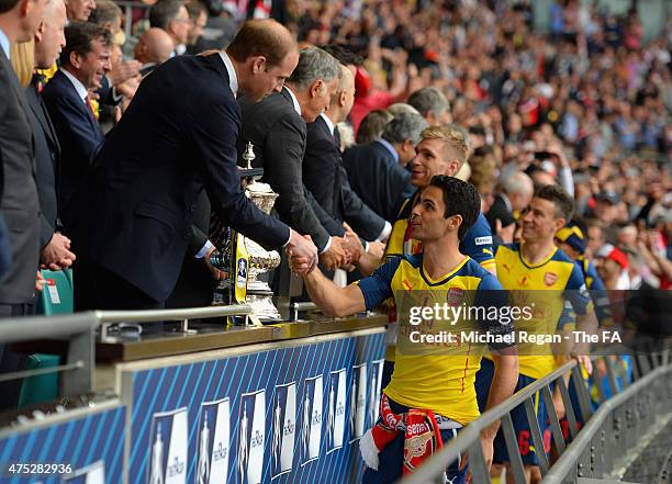 Mikel Arteta of Arsenal shakes hands with Prince William, Duke of Cambridge as he collects the trophy after the FA Cup Final between Aston Villa and...