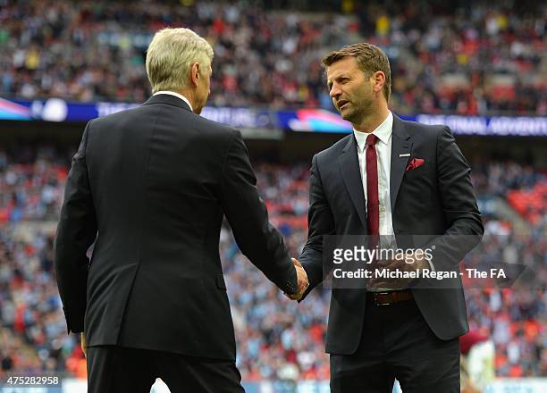 Tim Sherwood manager of Aston Villa shakes hands with Arsene Wenger manager of Arsenal after the FA Cup Final between Aston Villa and Arsenal at...