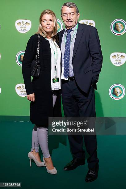 President Wolfgang Niersbach and his girlfriend Marion Popp pose at the green carpet prior to the DFB Cup Final between Borussia Dortmund and VfL...