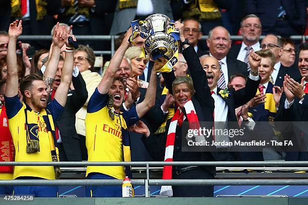 Nacho Monreal of Arsenal and Arsene Wenger manager of Arsenal lift the trophy after the FA Cup Final between Aston Villa and Arsenal at Wembley...