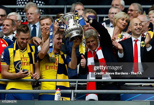 Nacho Monreal of Arsenal and Arsene Wenger manager of Arsenal lift the trophy after the FA Cup Final between Aston Villa and Arsenal at Wembley...