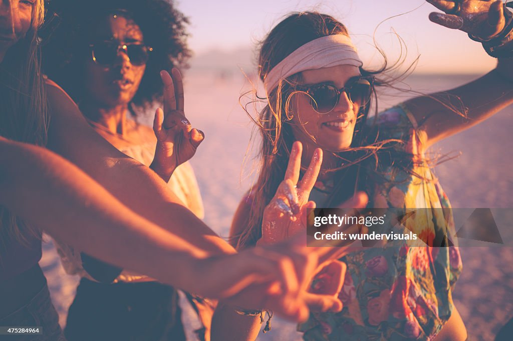 Meninas dançando em um beachparty ao pôr-do-sol