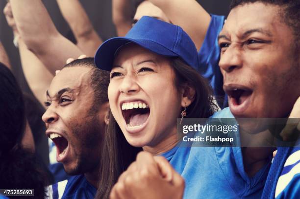 crowd of sports fans cheering - partisan photos et images de collection