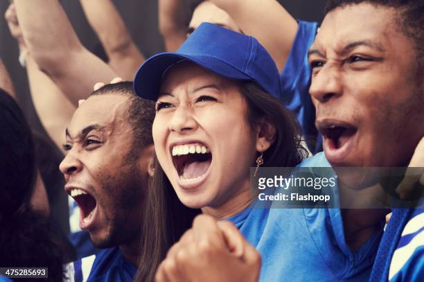 crowd of sports fans cheering - incoraggiamento foto e immagini stock
