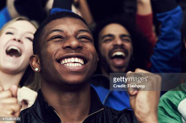 crowd of sports fans cheering - people cheering stock pictures, royalty-free photos & images