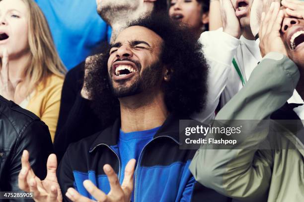 crowd of fans at sporting event - nederlaag stockfoto's en -beelden