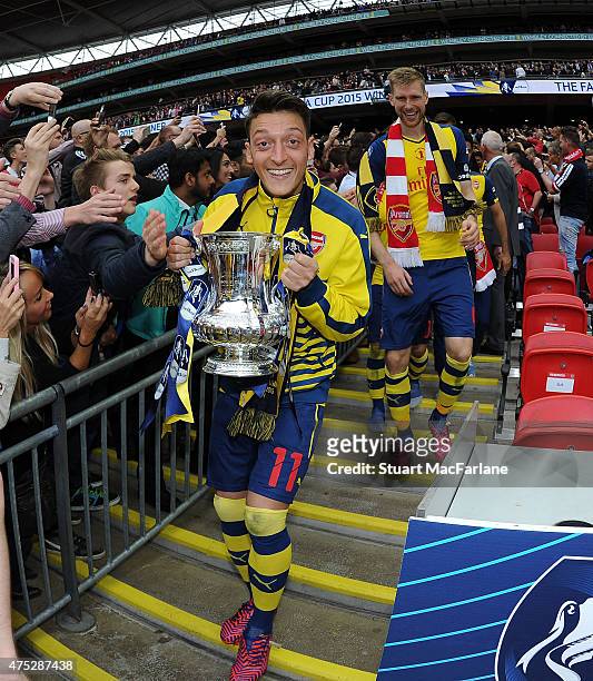 Arsenal's Mesut Oizil celebrates after the FA Cup Final between Aston Villa and Arsenal at Wembley Stadium on May 30, 2015 in London, England.