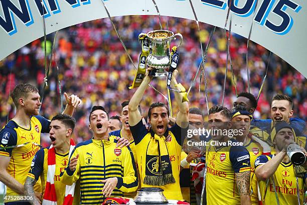 Mathieu Flamini of Arsenal lifts the trophy in celebration with team mates after the FA Cup Final between Aston Villa and Arsenal at Wembley Stadium...