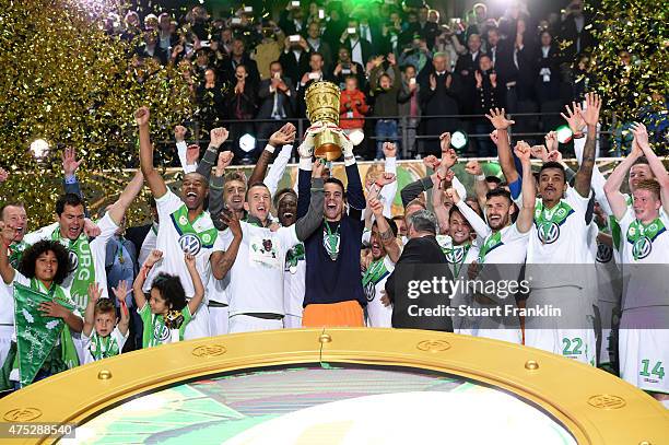 Captain Diego Benaglio of VfL Wolfsburg lifts the trophy with team mates to celebrate victory after the DFB Cup Final match between Borussia Dortmund...