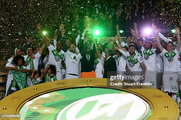 Captain Diego Benaglio of VfL Wolfsburg lifts the trophy with team mates to celebrate victory after the DFB Cup Final match between Borussia Dortmund...