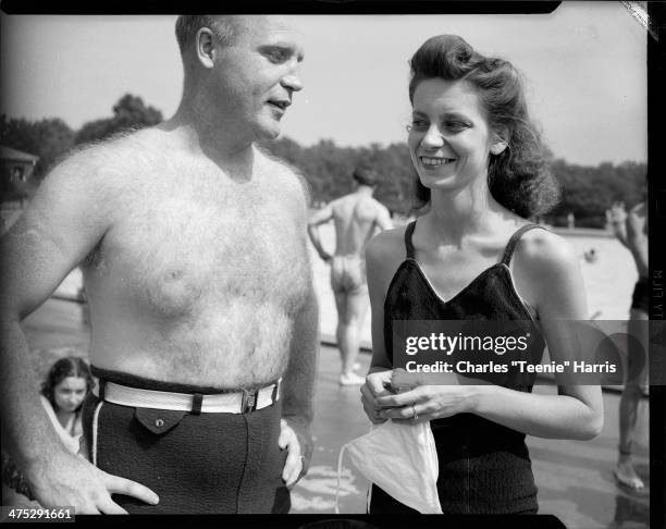 Man with hairy chest and woman wearing bathing suits at North Park pool for interracial picnic sponsored by the University of Pittsburgh Physical...