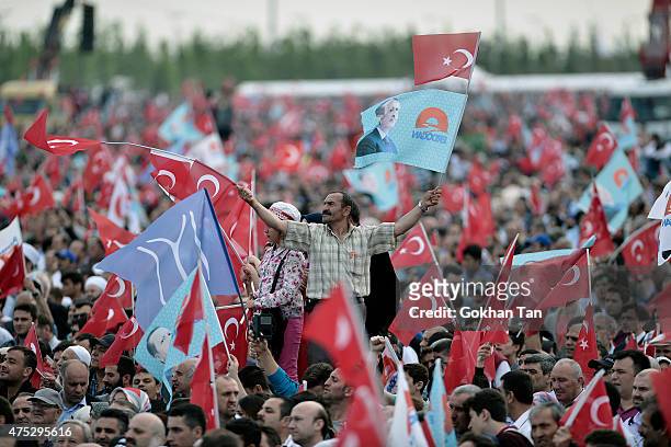 Supporters of Turkish President Tayyip Erdogan and Prime Minister and leader of the ruling Justice and Development Party Ahmet Davutoglu wave...