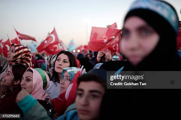 Supporters of Turkish President Tayyip Erdogan and Prime Minister and leader of the ruling Justice and Development Party Ahmet Davutoglu wave...