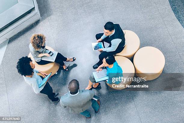 overhead view of business people in a meeting - overhead talking stock pictures, royalty-free photos & images