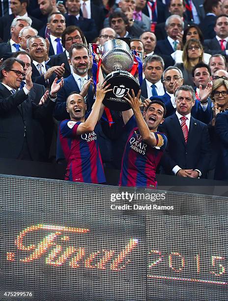 Barcelona players Andres Iniesta and Xavi Hernandez of FC Barcelona celebrate with the trophy after winning the Copa del Rey Final match between FC...