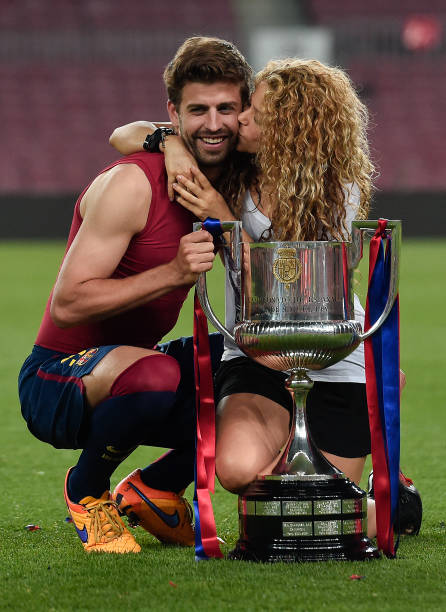 Barcelona's defender Gerard Pique and his wife Colombian singer Shakira pose with the trophy at the end of the Spanish Copa del Rey final football...