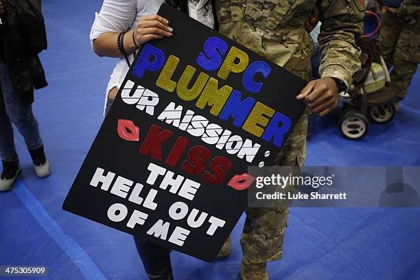Family members and loved ones brought homemade signs to greet returning members of the U.S. Army's 3rd Brigade Combat Team, 1st Infantry Division, at...
