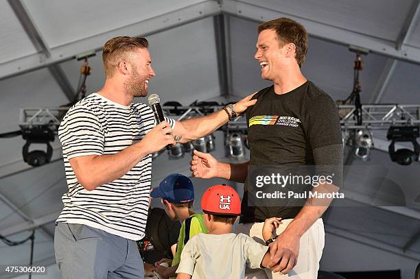 Teammates Julian Edelman and Tom Brady speak on stage at the Finish Line and Victory Celebration Party during the Best Buddies Challenge: Hyannis...