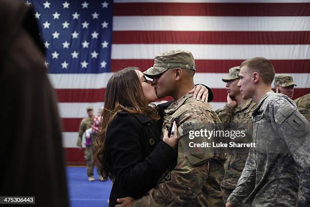 Spc. Jose Vargas of the U.S. Army's 3rd Brigade Combat Team, 1st Infantry Division, kisses his girlfriend Geneva Romero following a homecoming...