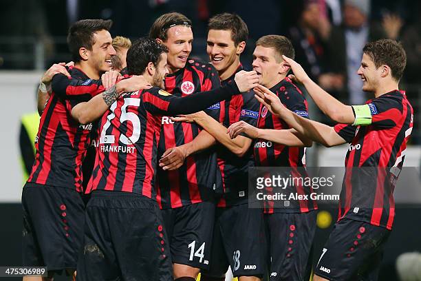 Alexander Meier of Frankfurt celebrates his team's second goal with team mates during the UEFA Europa League Round of 32 second leg match between...