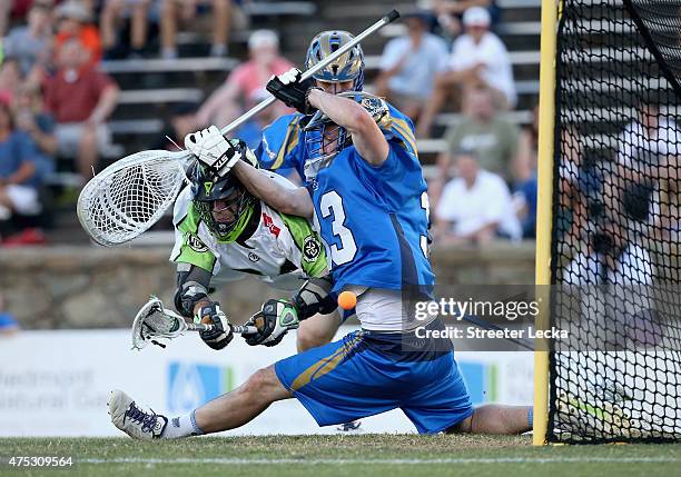 Tommy Palasek of the New York Lizards scores against Pierce Bassett of the Charlotte Hounds during their game at American Legion Memorial Stadium on...