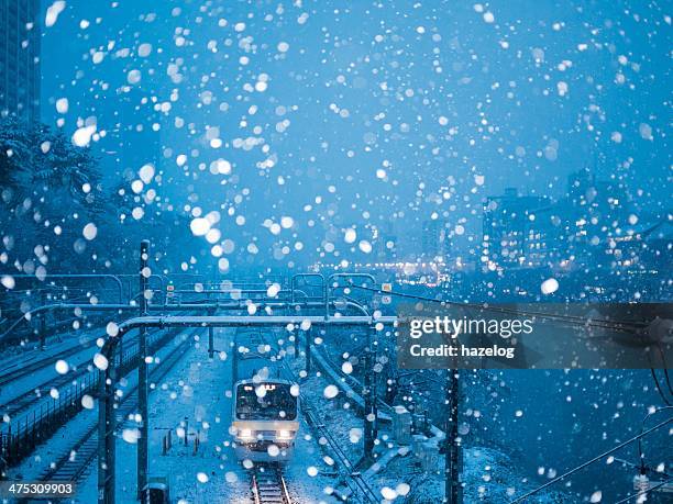 train running in heavy snow night - snow in tokyo ストックフォトと画像