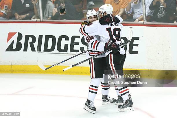 Jonathan Toews celebrates with Patrick Kane after Toews scores in the first period against the Anaheim Ducks in Game Seven of the Western Conference...