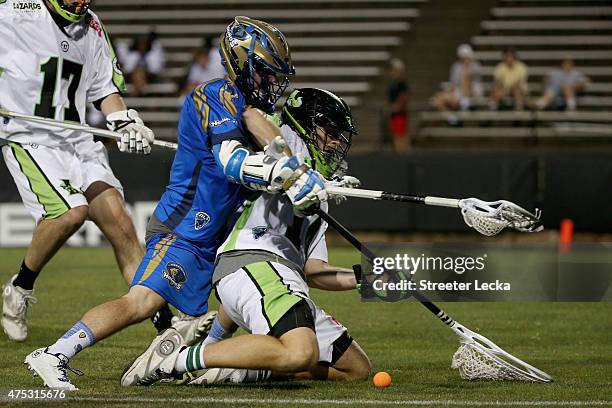 Joey Sankey of the Charlotte Hounds collides with Drew Adams of the New York Lizards during their game at American Legion Memorial Stadium on May 30,...