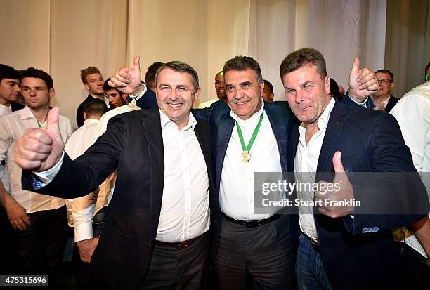 Head coach Dieter Hecking poses with Francisco Javier Garcia Sanz , Chairman of Volkswagen Group and Klaus Allofs, manager of VfL Volkswagen during...