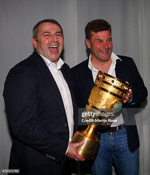 Manager Klaus Allofs and head coach Dieter Hecking pose with the DFB Cup during the VfL Wolfsburg Champions party after winning the German DFB Cup...