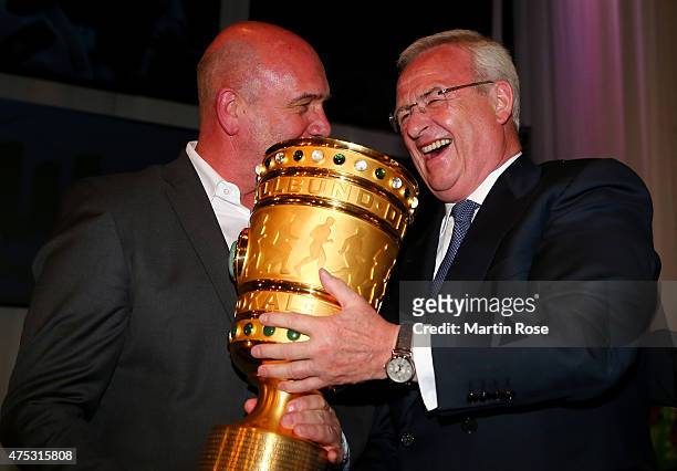 Chairman of the board of directors of Volkswagen Martin Winterkorn lifts the trophy during the VfL Wolfsburg Champions party after winning the German...