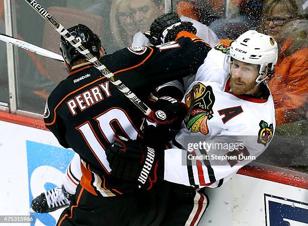 Corey Perry of the Anaheim Ducks checks Duncan Keith of the Chicago Blackhawks in the first period in Game Seven of the Western Conference Finals...