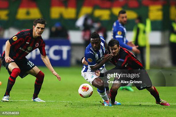 Silvestre Varela of Porto is challenged by Tranquillo Barnetta of Frankfurt during the UEFA Europa League Round of 32 second leg match between...